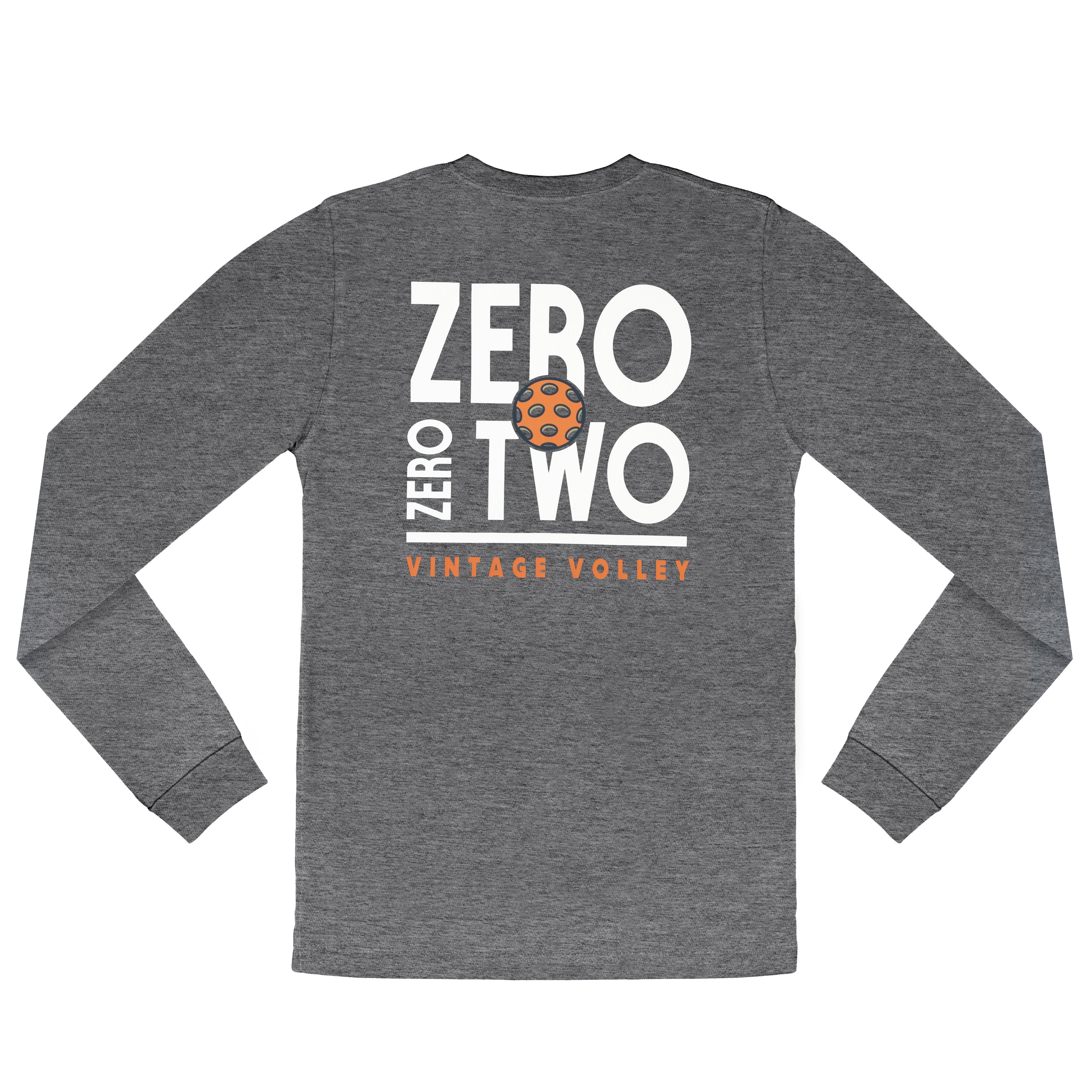 A flat lay of the Zero Zero Two Vintage Volley Long Sleeve Pickleball Shirt in Gray, showcasing its sleek and sporty design. The shirt features bold white text reading "Zero Zero Two," a vibrant orange pickleball graphic centered within the design, and the words "Vintage Volley" in standout orange beneath. The soft polyester-cotton blend fabric highlights its lightweight and versatile appeal, making it ideal for layering during cooler weather or wearing solo on the court. Perfectly tailored for pickleball e
