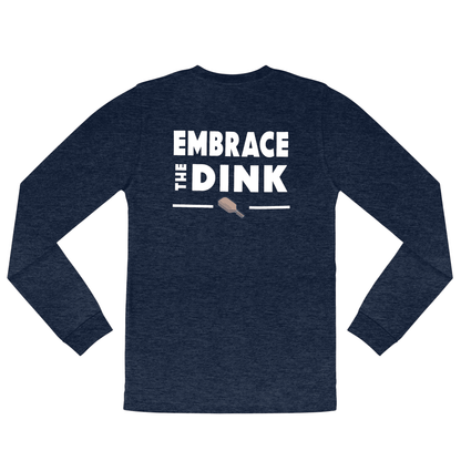 A flat lay of the Embrace the Dink long-sleeve pickleball shirt in Midnight Blue. This shirt combines breathable fabric with bold typography and a vibrant paddle graphic on the back, perfect for players seeking stylish pickleball clothing that enhances their performance on the court.

