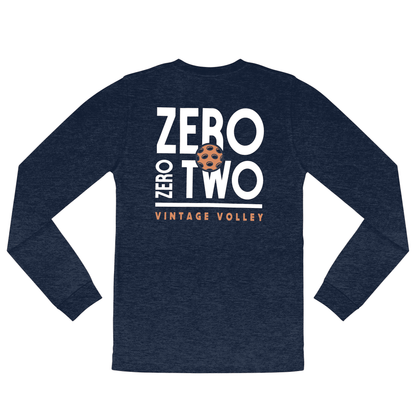 A flat lay of the Zero Zero Two Vintage Volley Long Sleeve Pickleball Shirt in Midnight. Featuring bold white text, a vibrant orange pickleball design, and the words “Vintage Volley,” this shirt adds a stylish edge to your pickleball wardrobe. Perfect for layering or wearing on its own, it’s a must-have for any pickleball game.